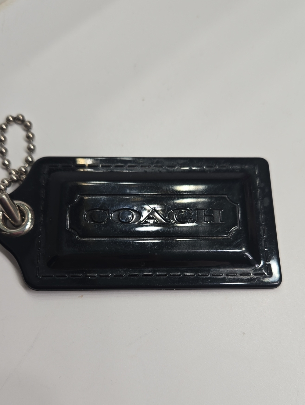 Coach Black Embossed Logo Plastic Hangtag